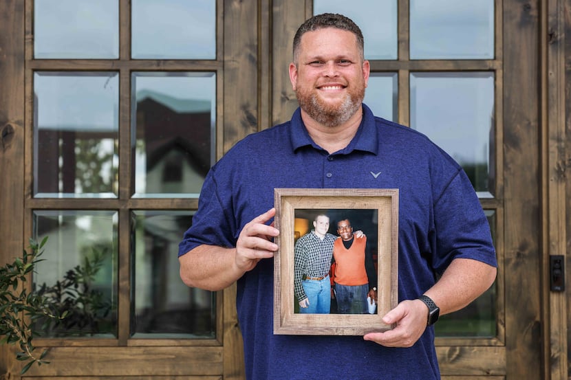 Tyler Tines Pride poses for a portrait in front of his home in Lindale as he holds a photo...