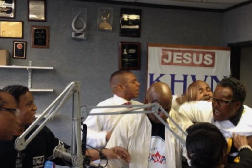  Two men are seen holding back Dwaine Caraway from John Wiley Price in a video of Mondayâs...