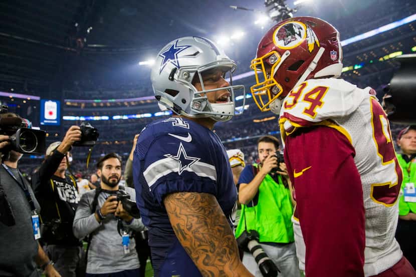 Dallas Cowboys quarterback Dak Prescott (4) hugs Washington Redskins outside linebacker...