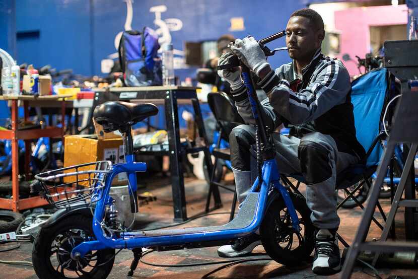 Boaz Bikes lead mechanic Joei Wilson repairs a bike at the company's facility in Detroit.