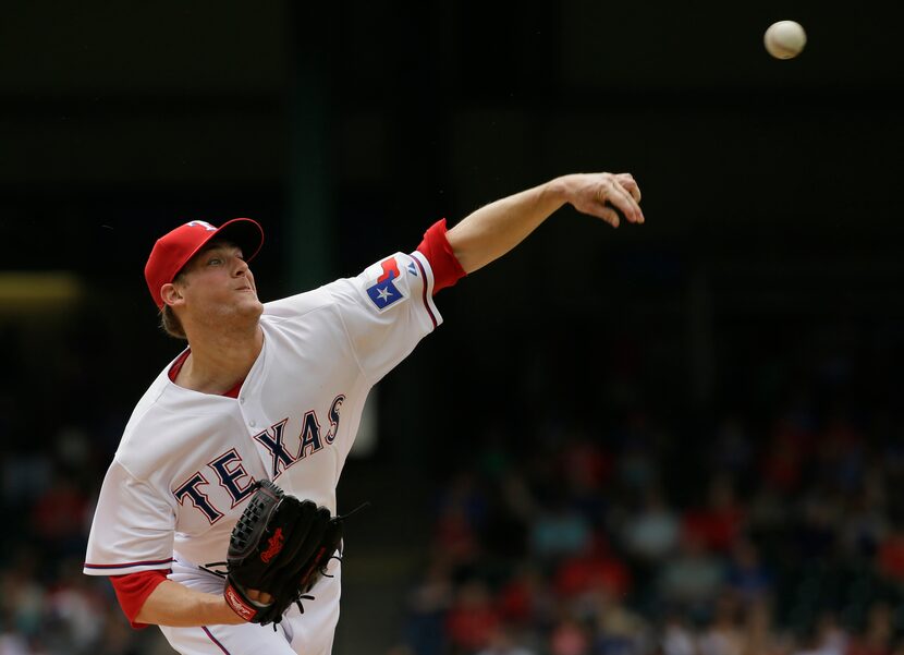 Texas Rangers starting pitcher Ross Detwiler throws during the first inning of a baseball...