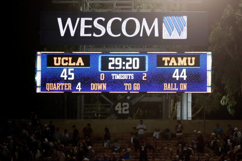 The scoreboard is seen after UCLA defeated Texas A&M in an NCAA college football game,...