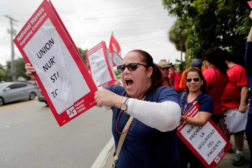 Nurse Cindy Rodriguez shouts during a one-day strike outside of Tenet Health's Palmetto...