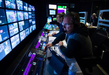FOX Sports' Chuck McDonald (right) and Rich Russo (center) work in the control room during...