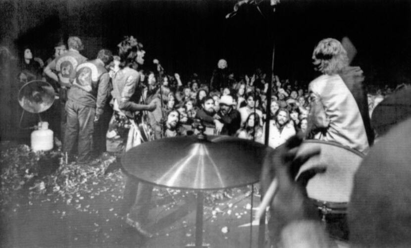  Keith Richards (left) and Mick Jagger sing on the rose petal-littered stage at Altamont...