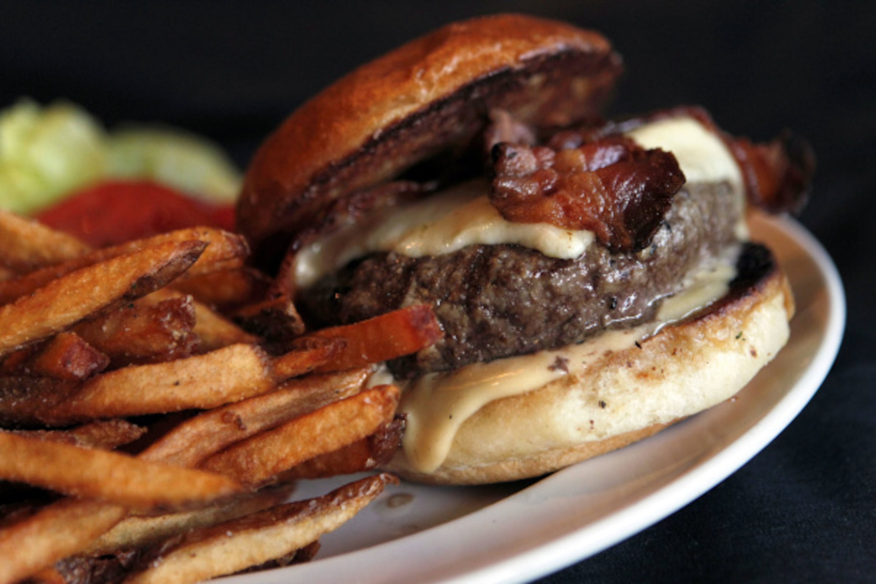 At The Grape, Chef Brian Luscher gives his famous cheeseburger ($14) the bistro treatment,...