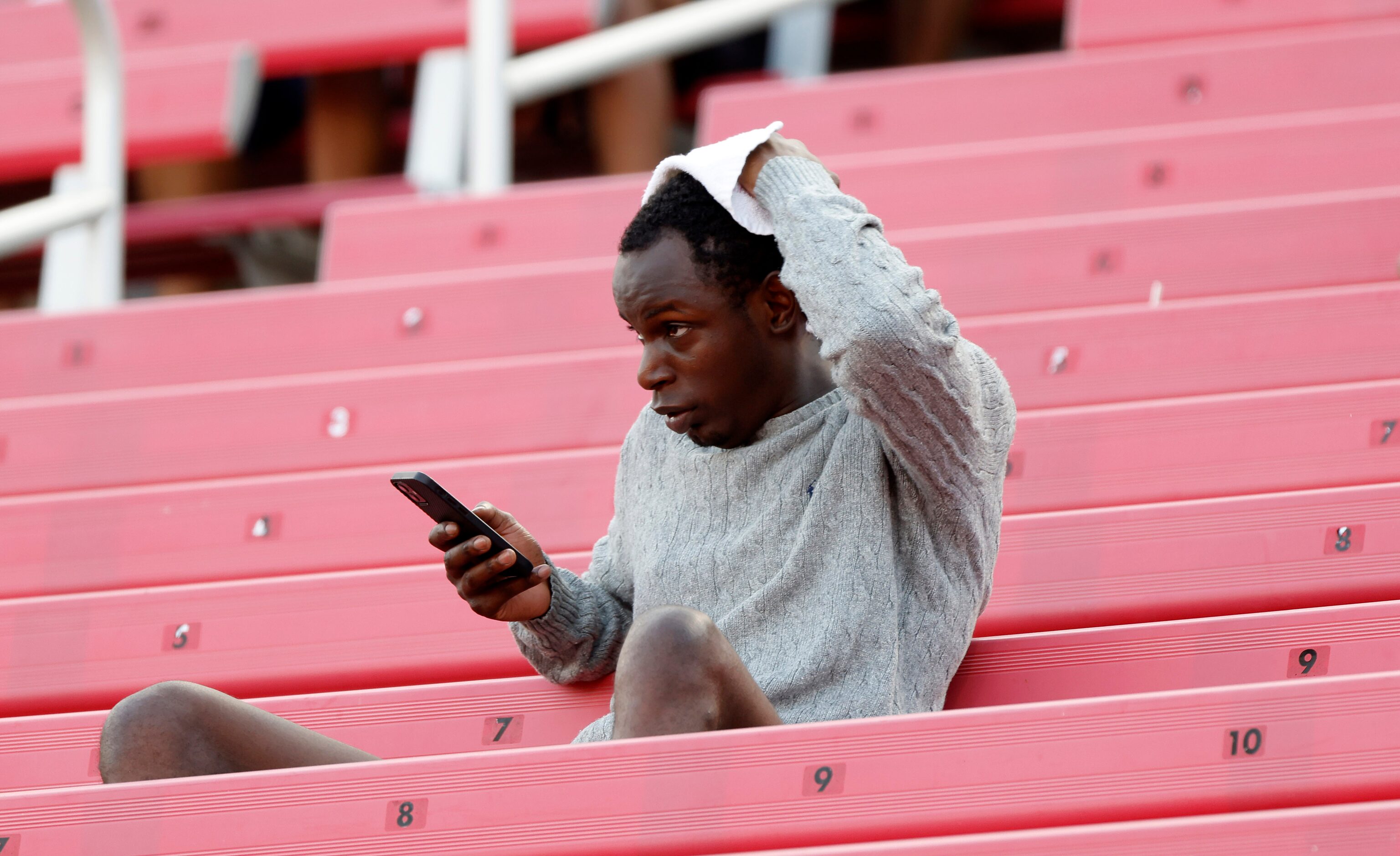 Fan Larren Bennett of Dallas tries to keep cool in the stands before Duncanville faces South...