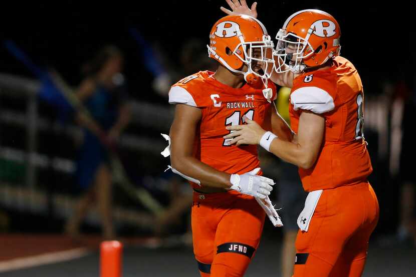 Rockwall's Jaxon Smith-Njigba (11) and Braedyn Locke (8) celebrate after connecting for a...