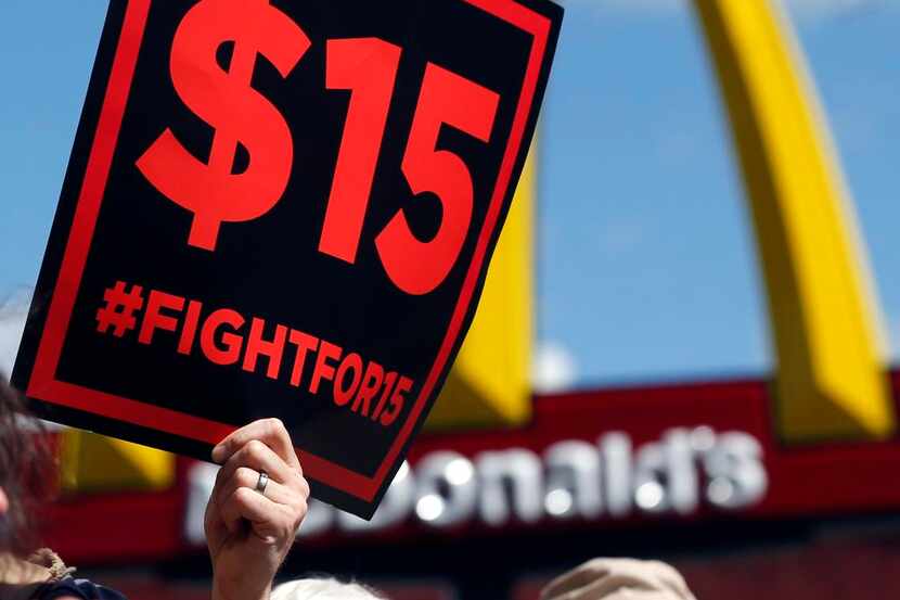
FILE--Supporters of a $15 minimum wage for fast food workers rally in front of a McDonald's...