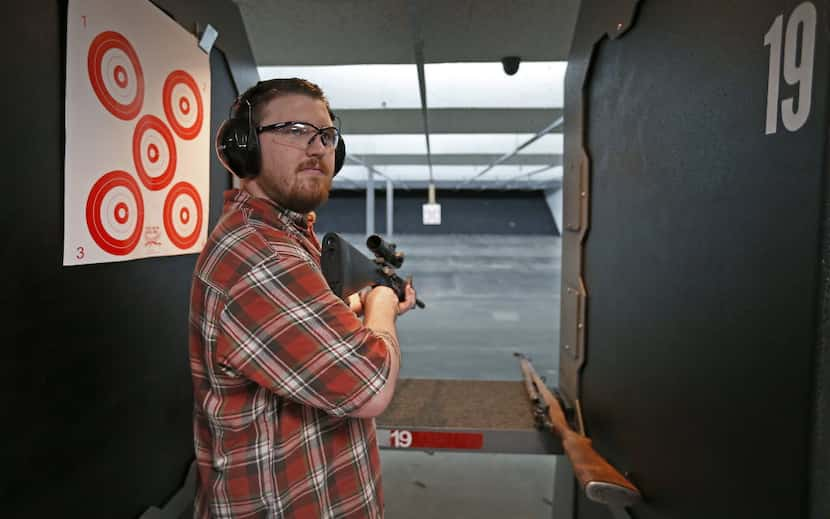 Ben Allen poses for a photograph with his AR-15 rifle manufactured by Runner Runner Guns at...