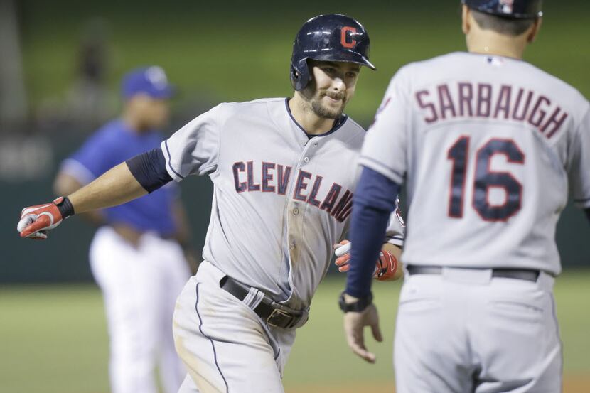 Cleveland Indians Lonnie Chisenhall, left,  rounds the bases past third base coach Mike...