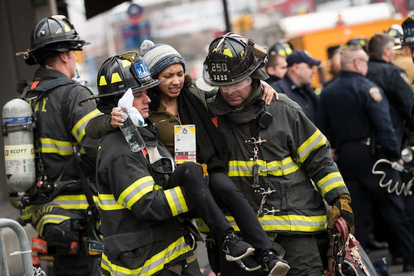 NEW YORK, NY - JANUARY 4: Members of the New York City Fire Department carry an injured...