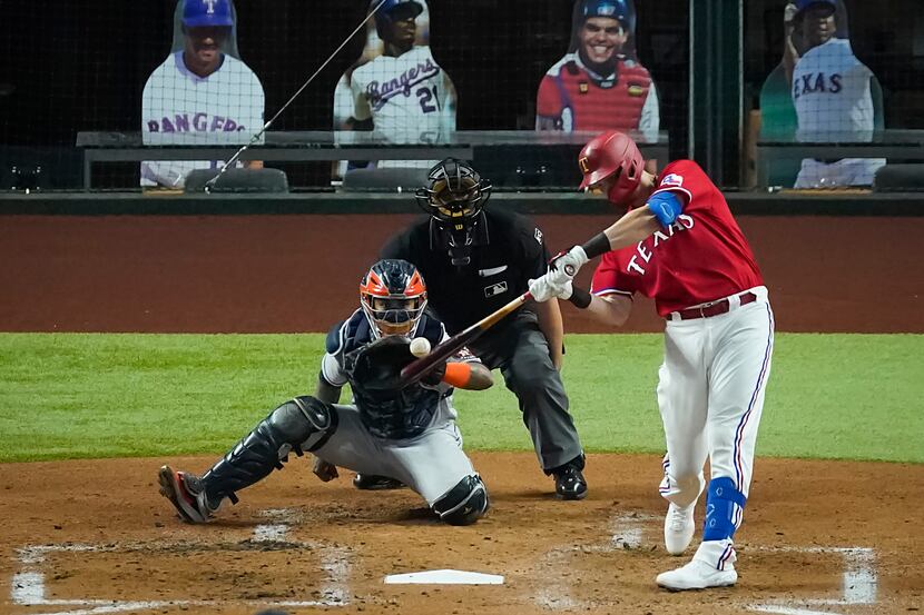 Texas Rangers catcher Sam Huff hits a solo home run as Houston Astros catcher Martin...