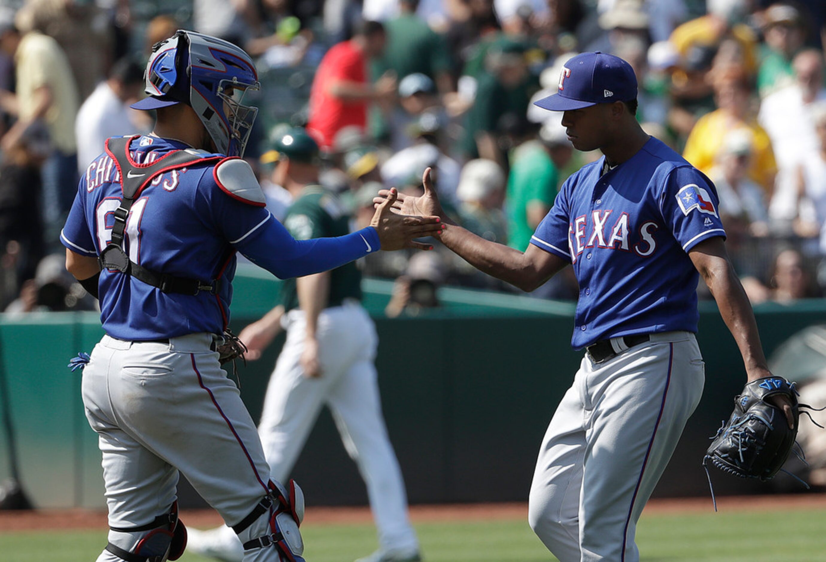 Texas Rangers catcher Robinson Chirinos, left, celebrates with pitcher Jose Leclerc after...