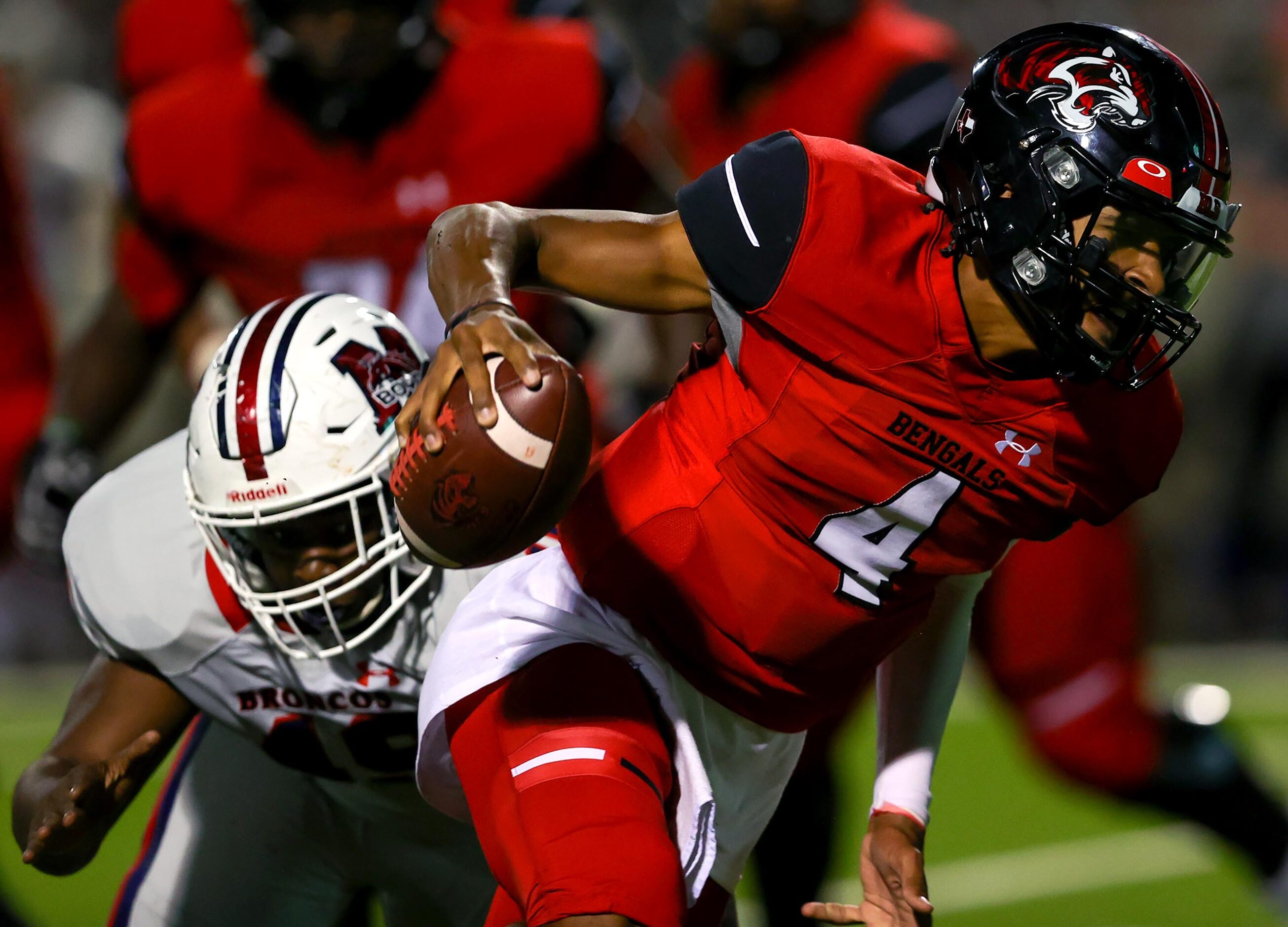 Denton Braswell quarterback Keegan Byrd (4) tries to avoid McKinney Boyd defensive lineman...