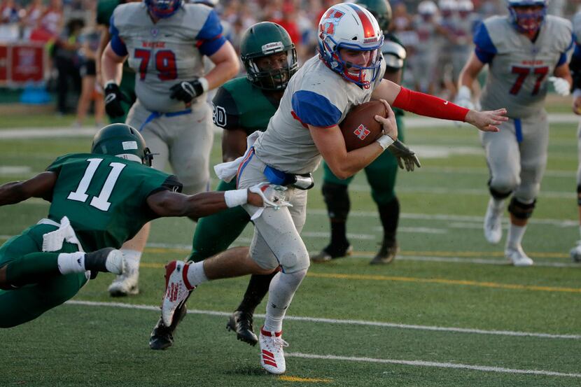 Midlothian Heritage quarterback Cade Sumbler (6) is tackled by Kennedale's Keirahyin Brown...