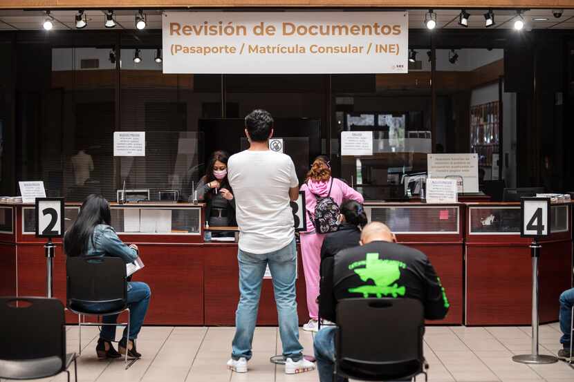 File photos of Mexican citizens running errands for their passports and other documents at...
