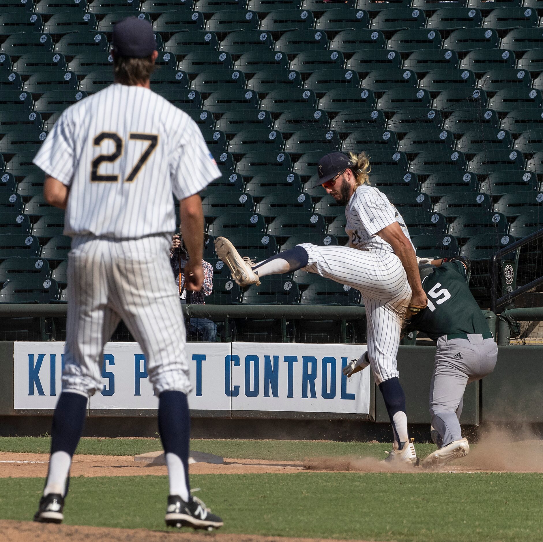 Keller Gray Rowlett, (21), tags out Houston Strake Jesuit James Vaquero, (15), as Eric...