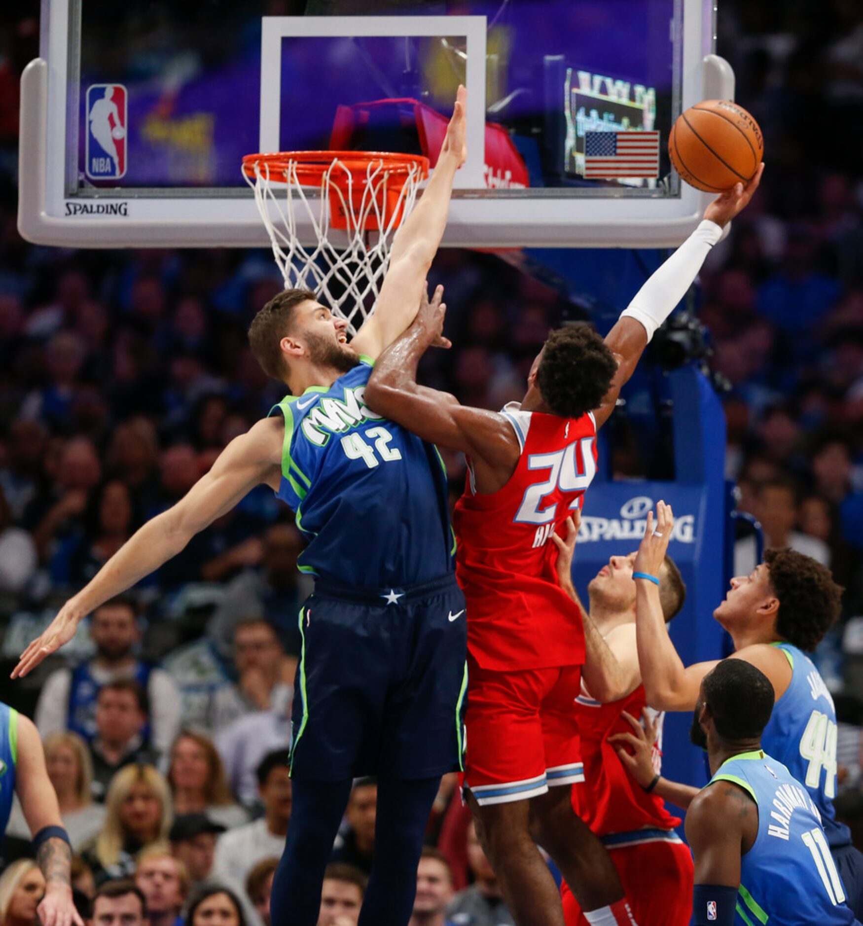 Sacramento Kings guard Buddy Hield (24) goes up for a shot as Dallas Mavericks forward Maxi...