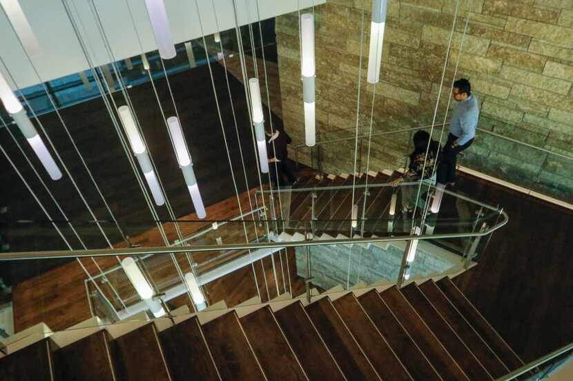 Employees descend the main staircase in the three story building of the new TD Ameritrade...