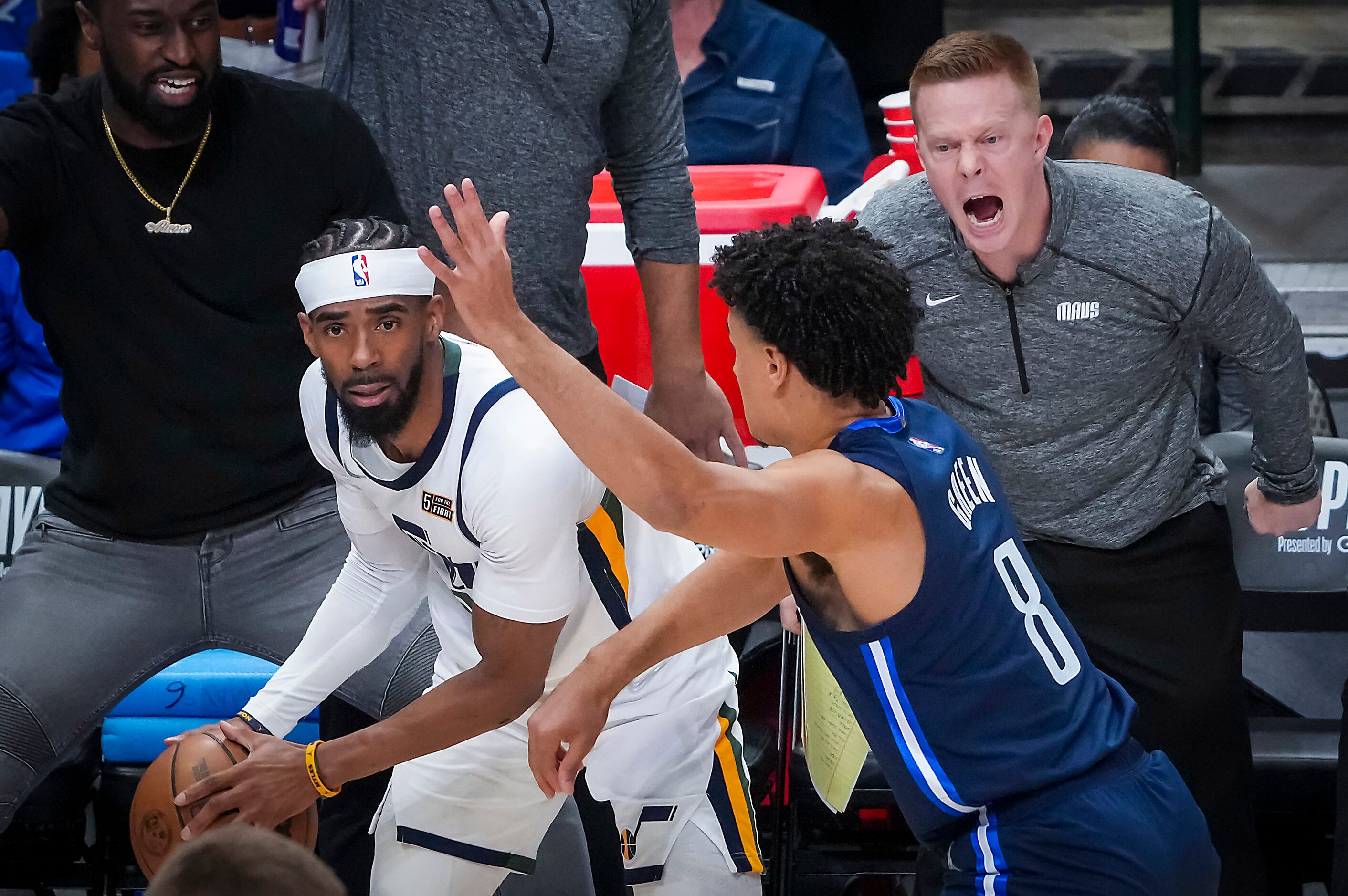 Dallas Mavericks assistant coach Sean Sweeney yells from the bench as guard Josh Green (8)...