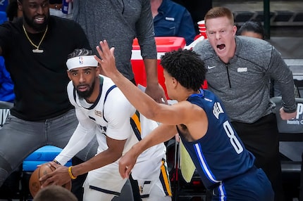 Dallas Mavericks assistant coach Sean Sweeney yells from the bench as guard Josh Green (8)...