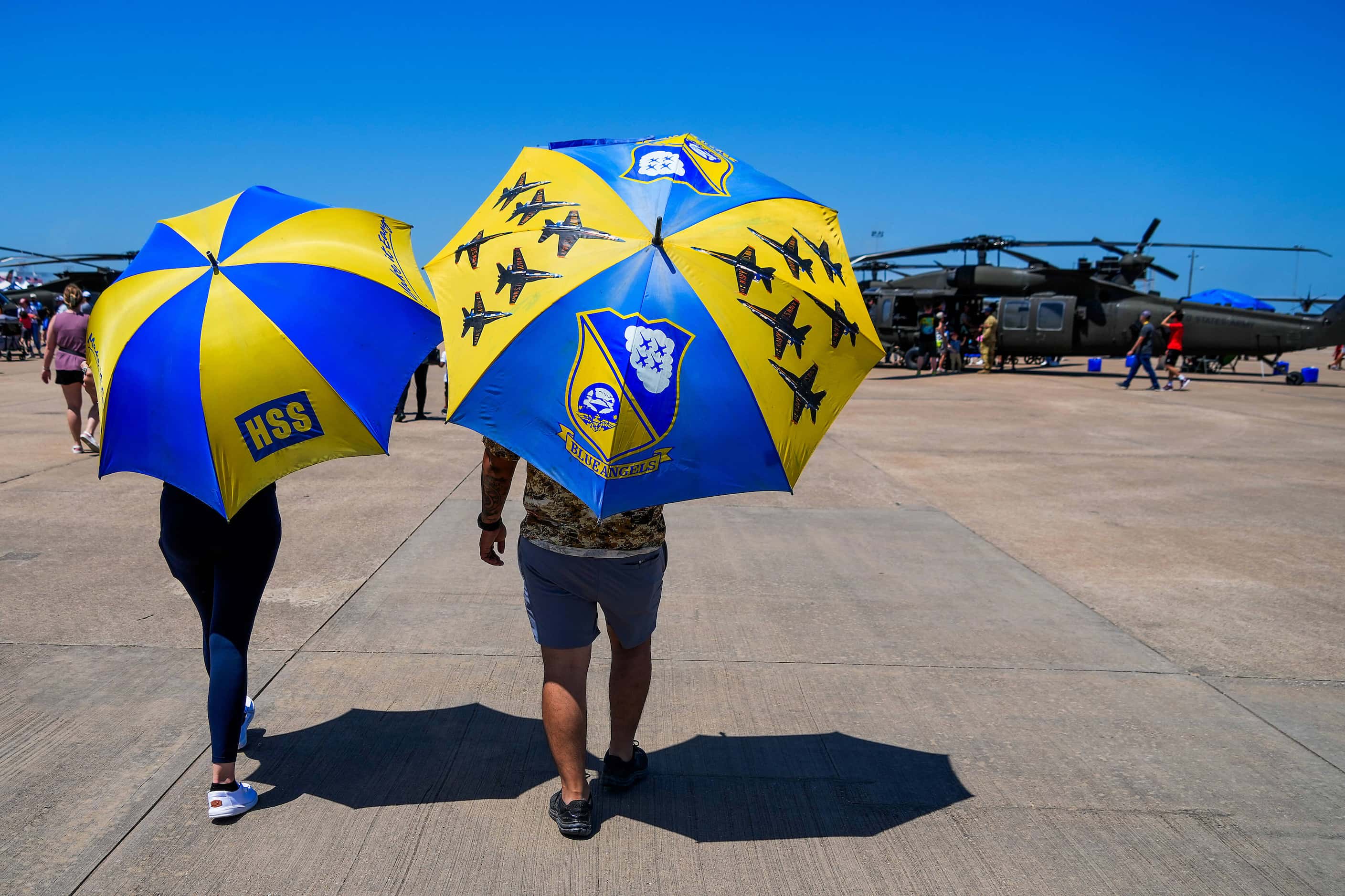 Spectators find shade under umbrellas before the Blue Angels performed at the Wings Over...