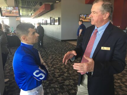 Lone Star Park President and General Manager Scott Wells talks with jockey Richard Eramia at...