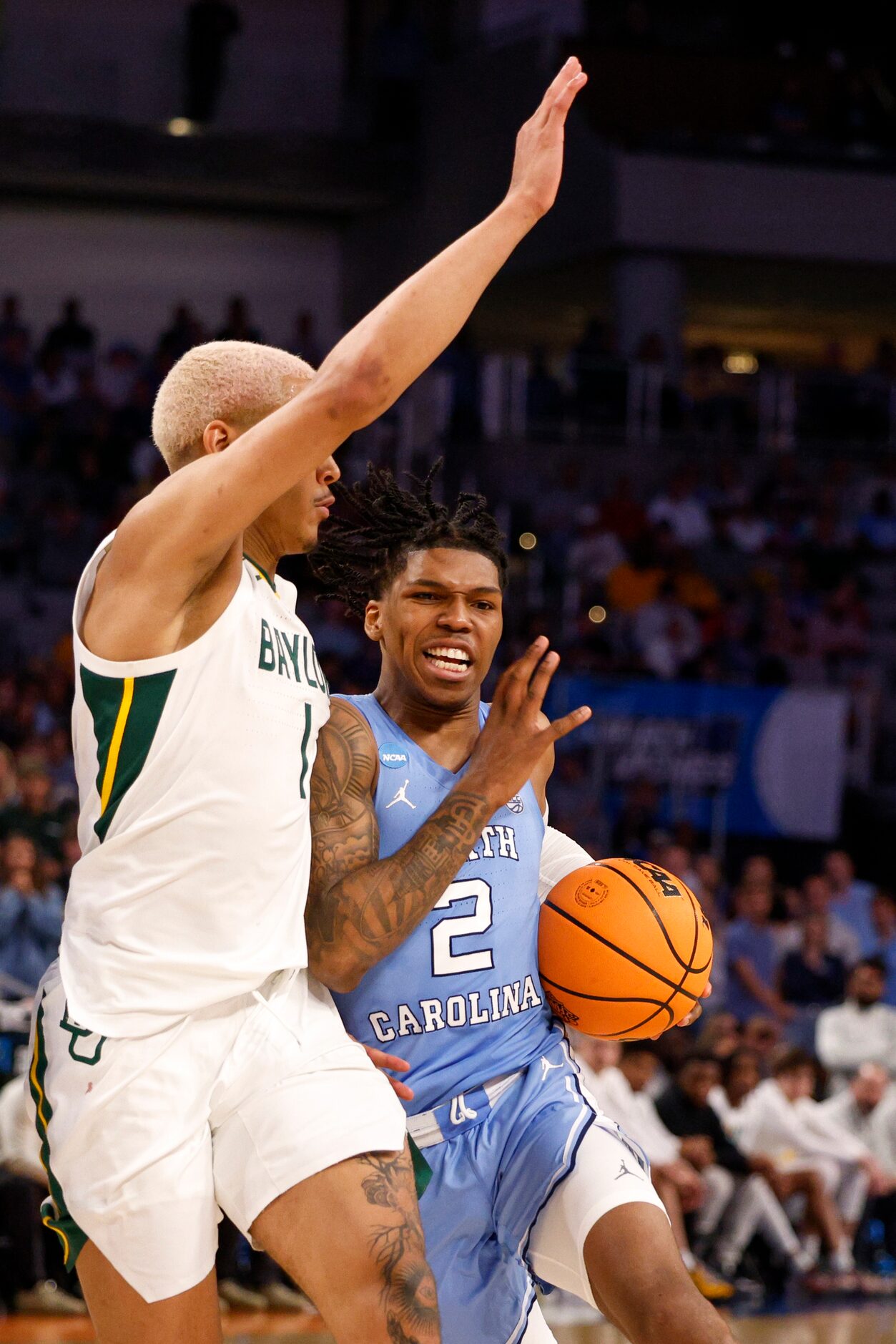 North Carolina Tar Heels guard Caleb Love (2) drives to the basket against Baylor Bears...