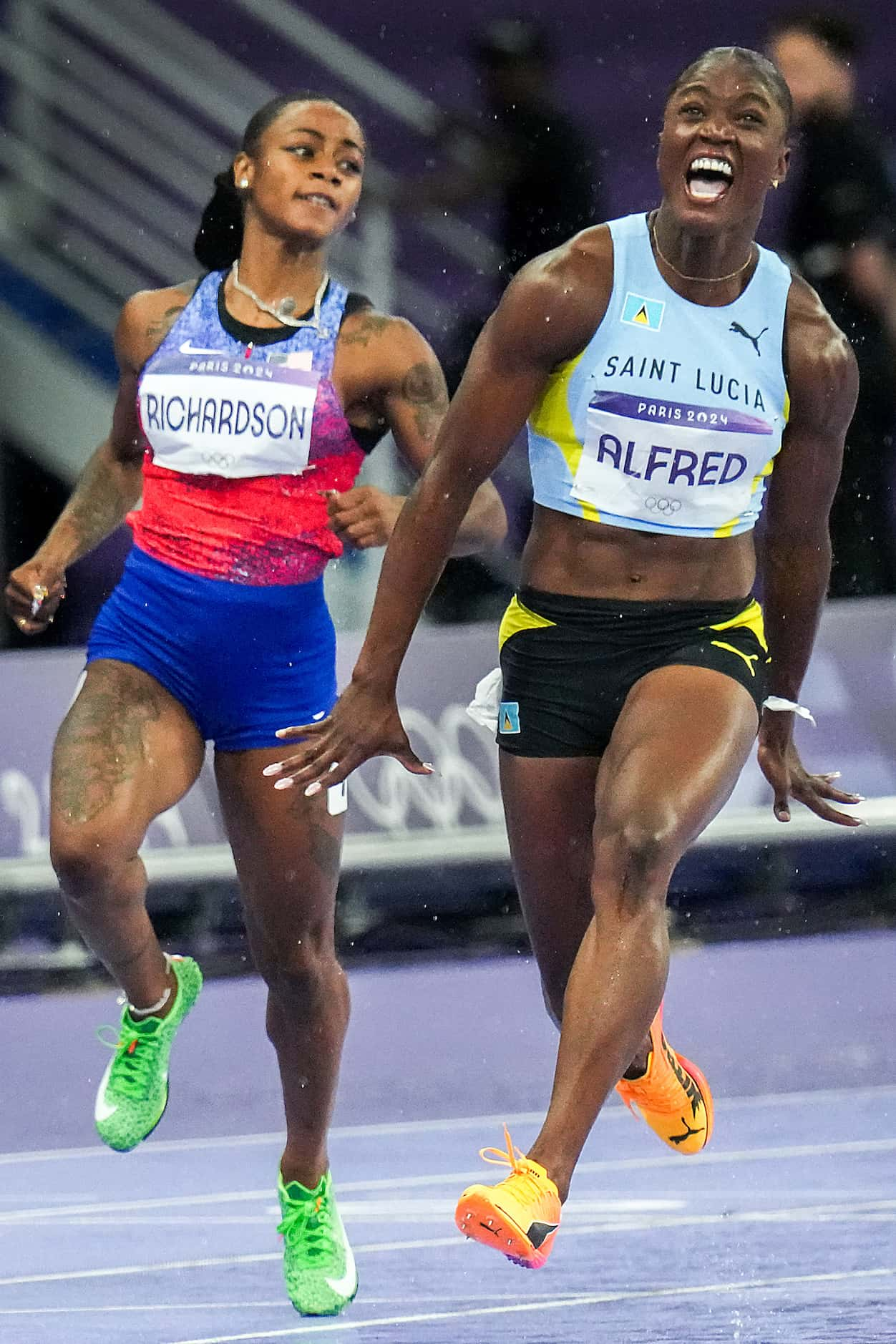 Julien Alfred of Saint Lucia celebrates as she finishes ahead of Sha'carri Richardson of the...