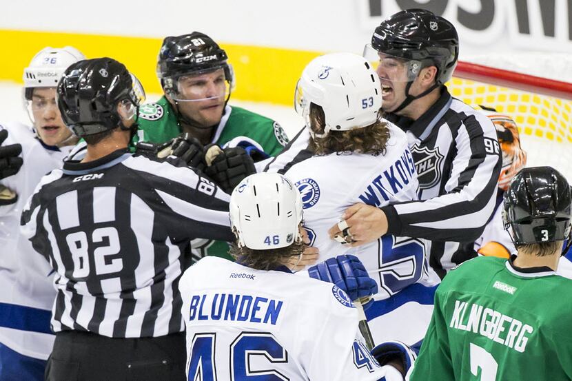 Referees separate Dallas Stars left wing Antoine Roussel (21) from Tampa Bay Lightning...