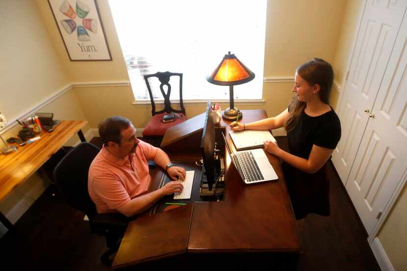  Hannah Faulkner, with her father Ed, work in his office at the family's home in Prosper,...