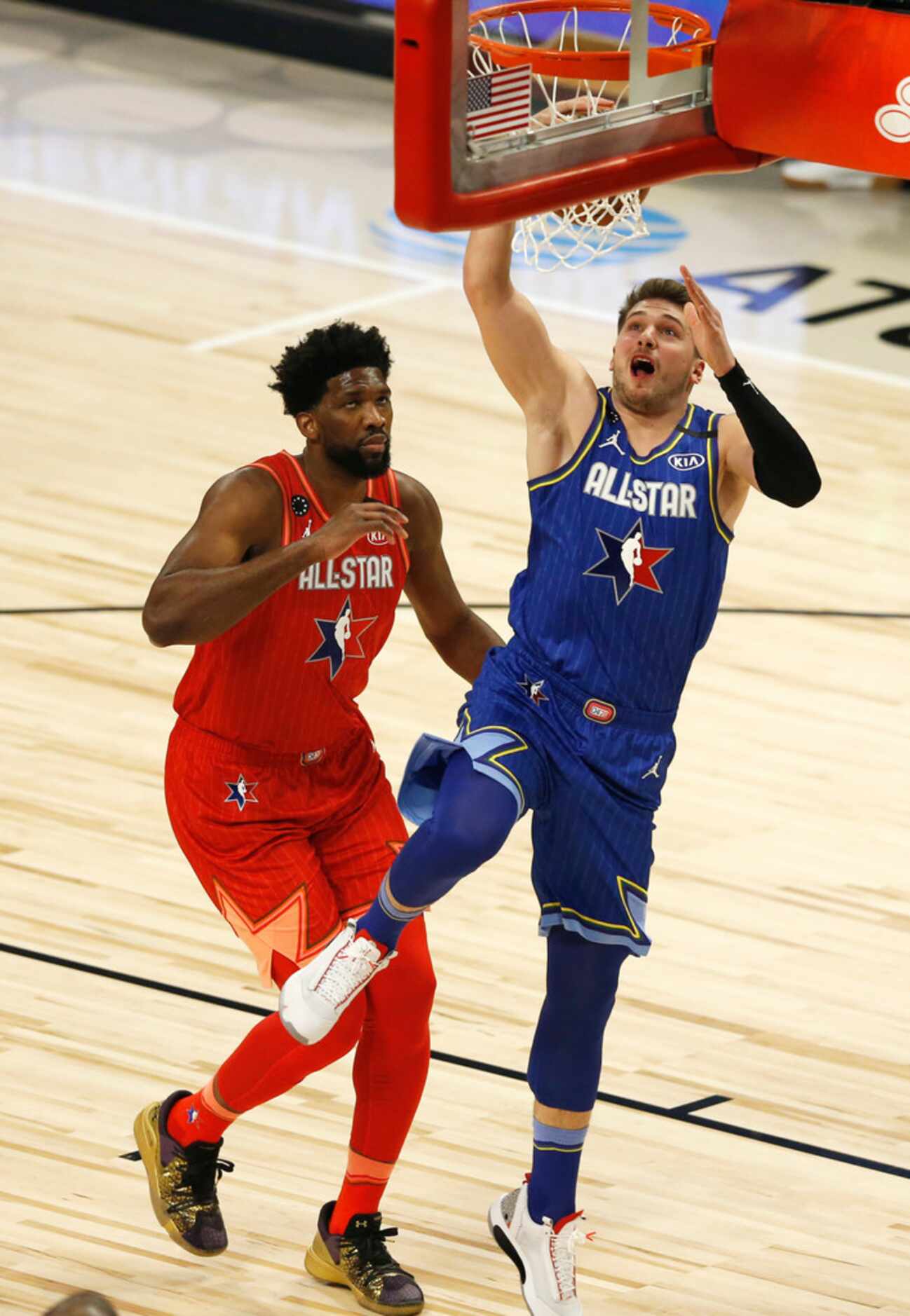 Team LeBron's Luka Doncic (2) dunks the ball in front of Team Giannis's Joel Embid (24)...