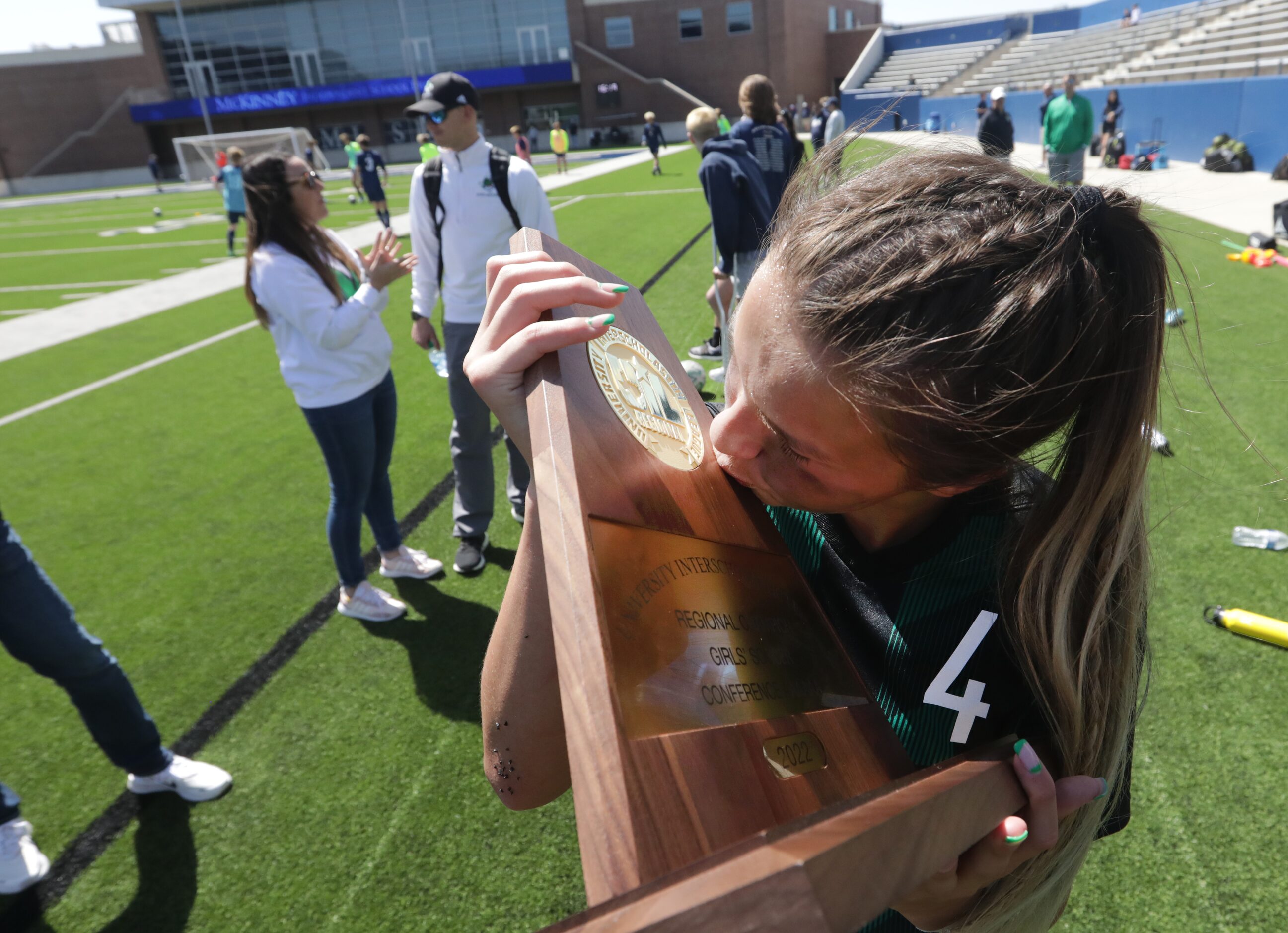 Southlake Carroll player #4, Kenzi Tufts, kisses the trophy after winning a Class 6A Region...