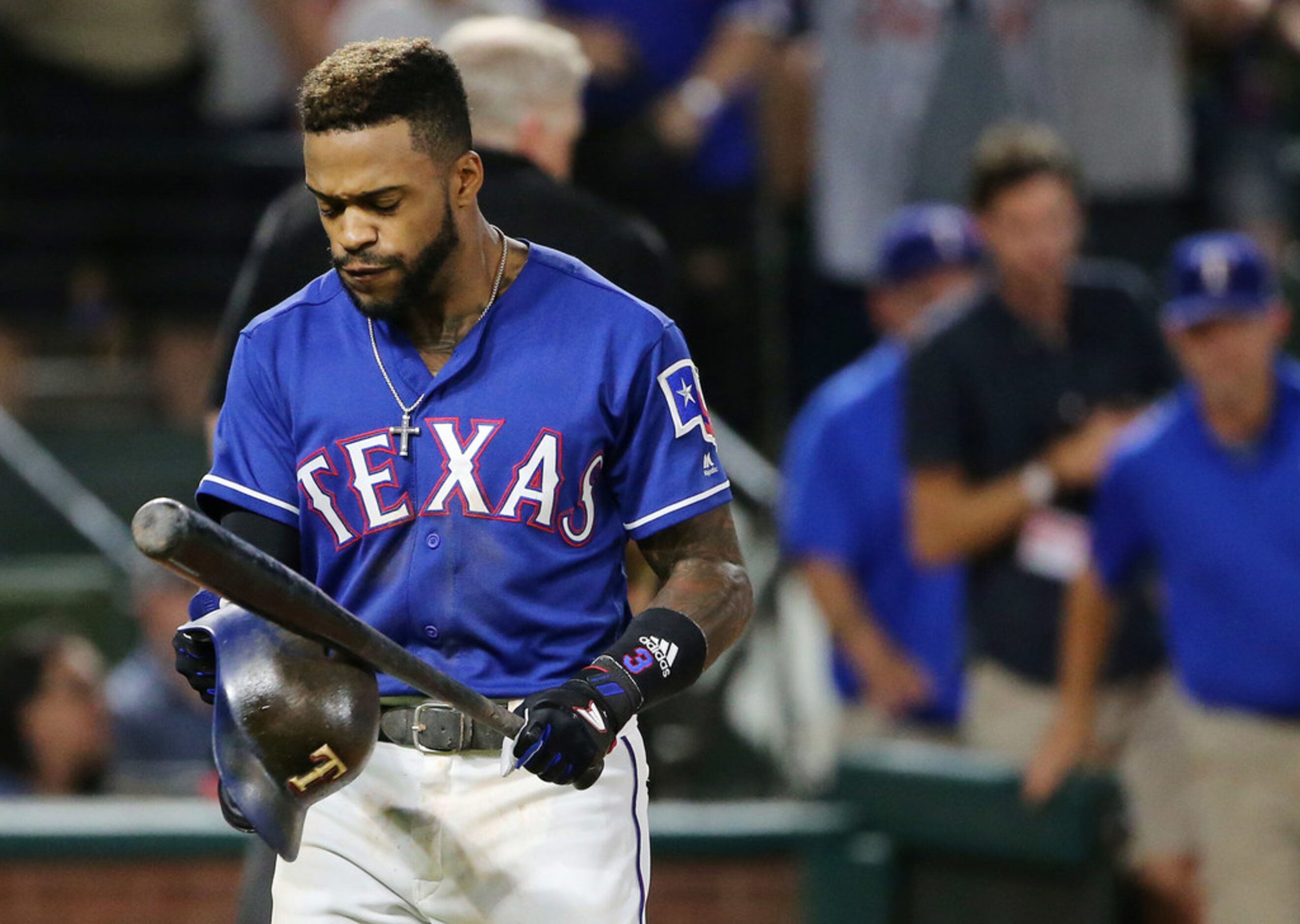 Texas Rangers centerfielder Delino DeShields (3) hits his helmet and bat together after...