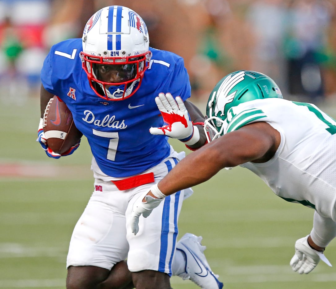 Southern Methodist Mustangs running back Ulysses Bentley IV (7) gives a stiff arm to North...