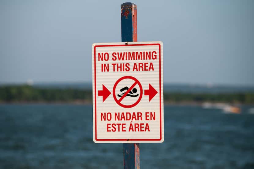 Signage indicating no swimming near boating docks is displayed at Joe Pool Lake at Lynn...