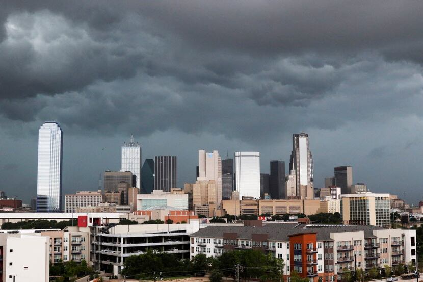 Clouds gather over the Dallas skyline before it rained in North Texas on Friday, July 15,...