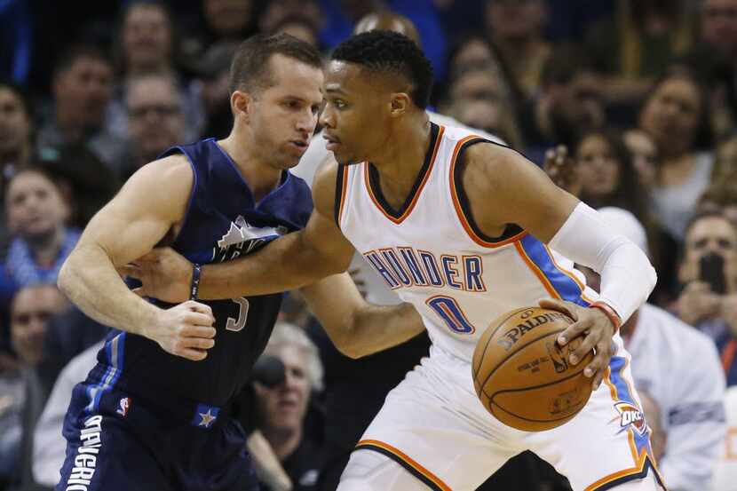 Oklahoma City Thunder guard Russell Westbrook (0) drives against Dallas Mavericks guard J.J....