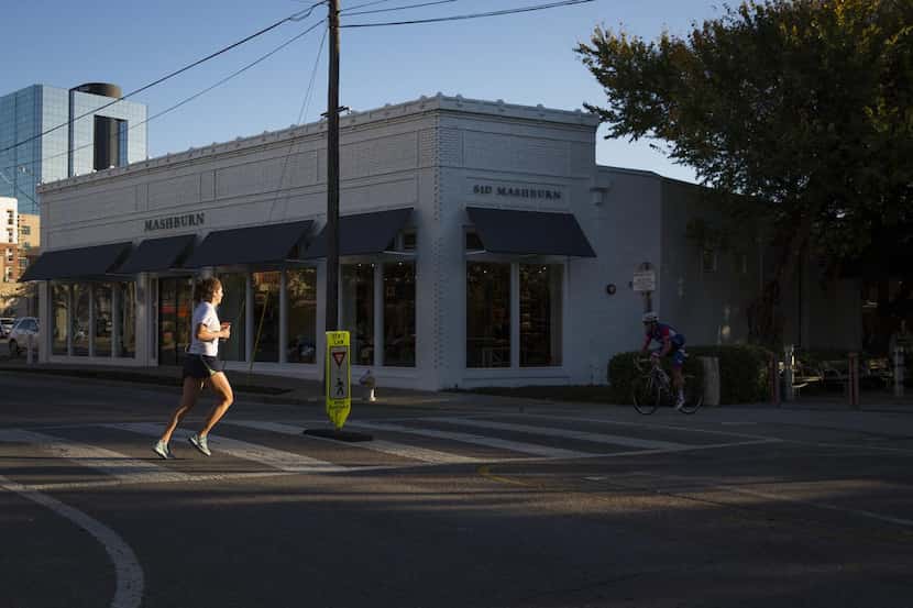 
Runners and cyclists on the Katy Trail pass the at the Sid & Ann Mashburn store in 2015. 
