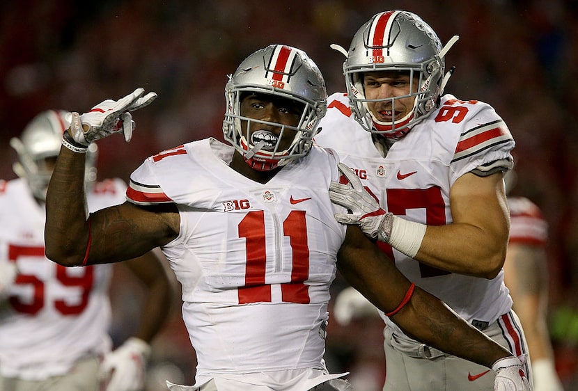 MADISON, WI - OCTOBER 15: Jalyn Holmes #11 and Nick Bosa #97 of the Ohio State Buckeyes...