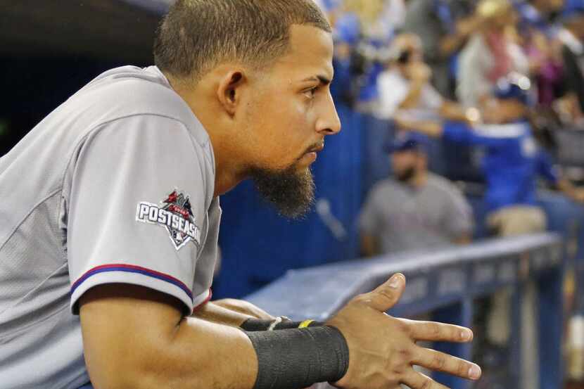 Texas Rangers second baseman Rougned Odor (12) watches the Blue Jays celebration the field...