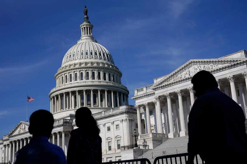FILE - People walk outside the U.S Capitol building in Washington, June 9, 2022. (AP...