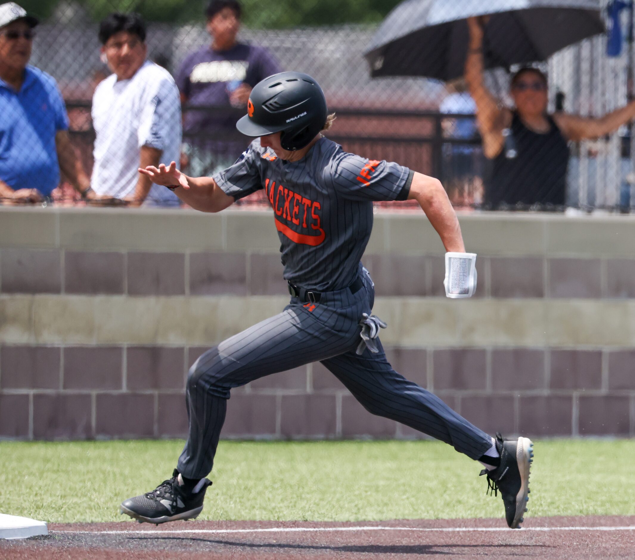 Rockwall junior Pearson Riebock (10) rounds third base before returning to first base in the...