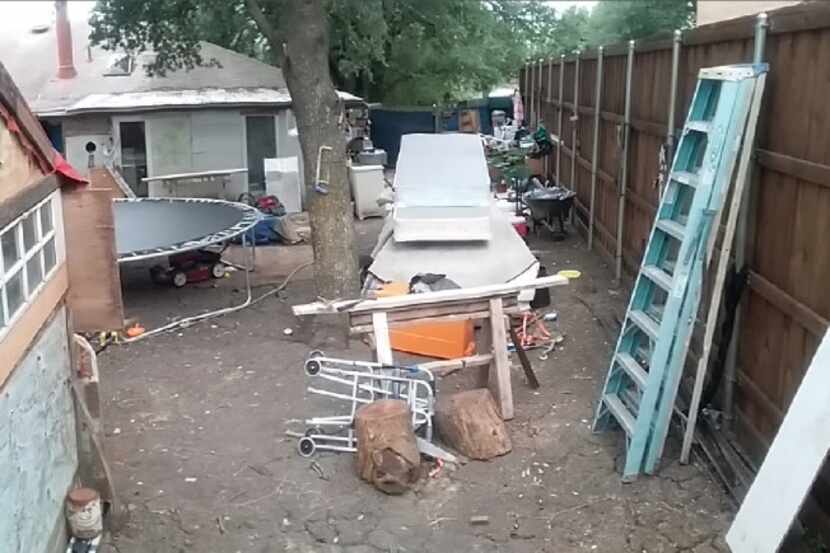 Terry Smith said his neighbor is running a junk business out of his back yard in Sachse. He...