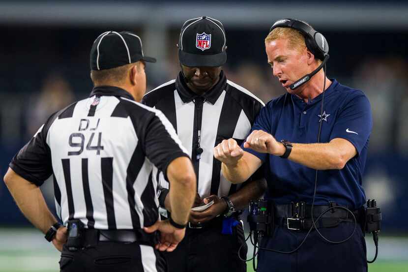 Dallas Cowboys head coach Jason Garrett talks to game officials during the third quarter of...