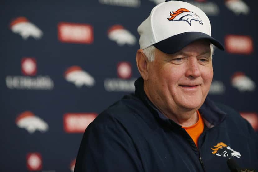 Denver Broncos defensive coordinator Wade Phillips jokes with reporters after an NFL...