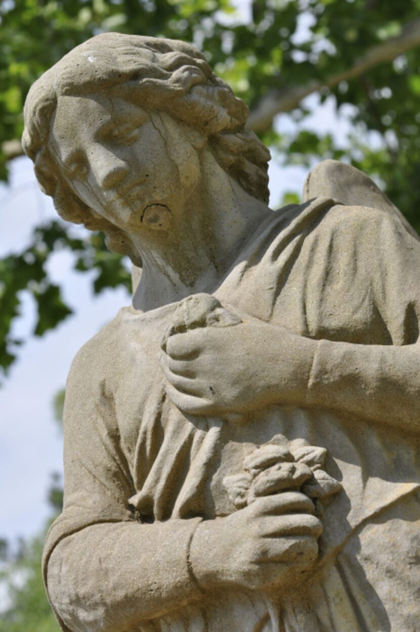  An angel statue adds to the picturesque beauty of the Mansion on Sawmill Lake's garden.