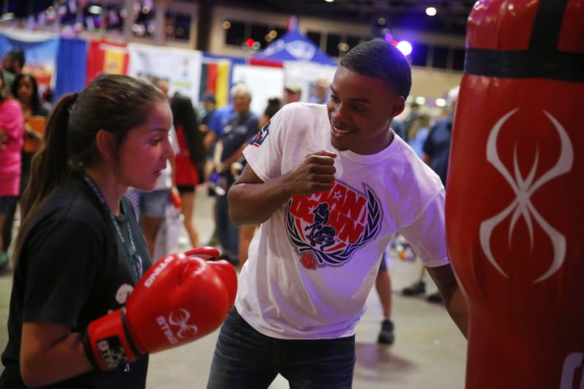 Former USA Olympic boxer Errol Spence, Jr. of DeSoto shows Desiree Tijerina of Forney, Texas...