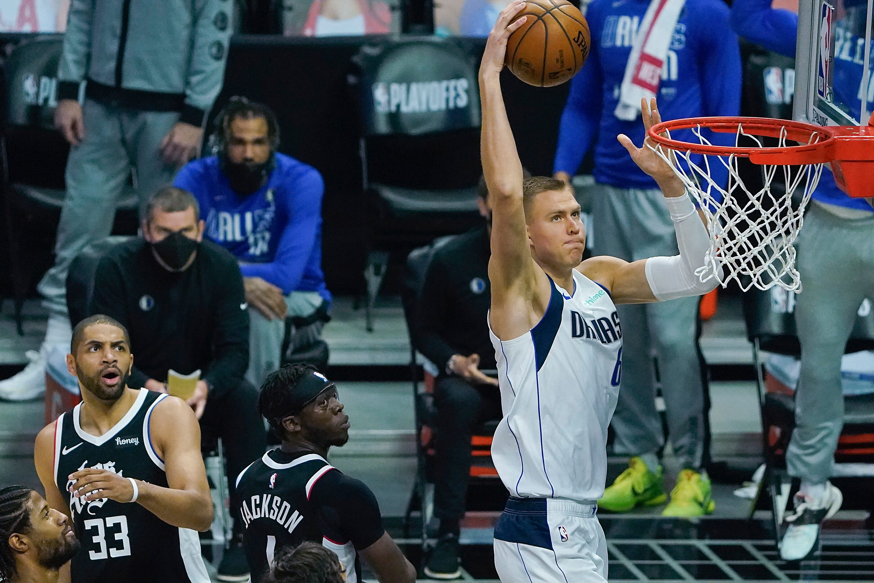 Dallas Mavericks center Kristaps Porzingis (6) goes up for a dunk past LA Clippers guard...